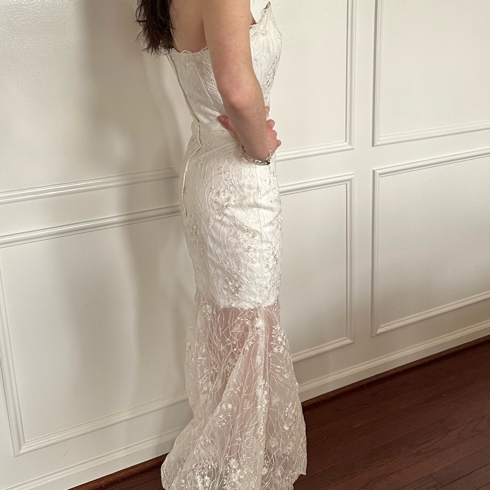 Ivory strapless gown with lace overlay.